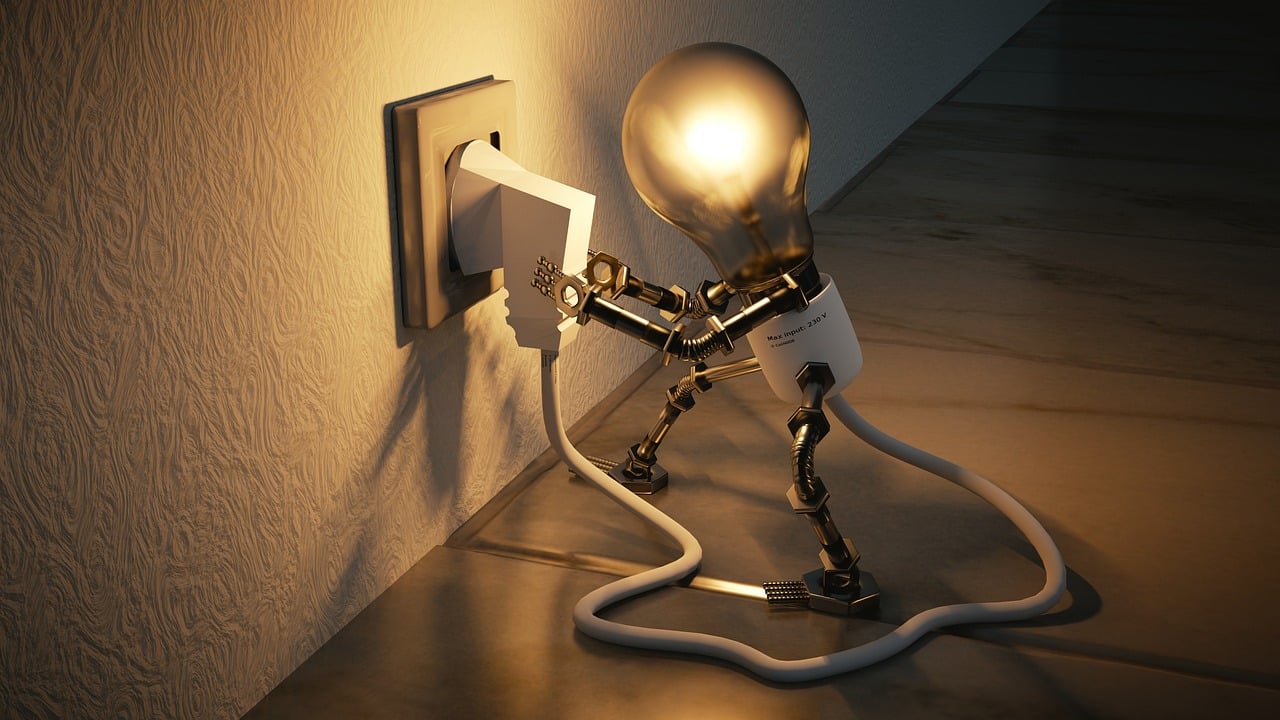 Lightbulb character plugging into an outlet, symbolizing the capture and activation of creative ideas, relevant to organizing and prioritizing thoughts.